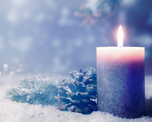 Christmas stock photo of candle and snowy pine cone